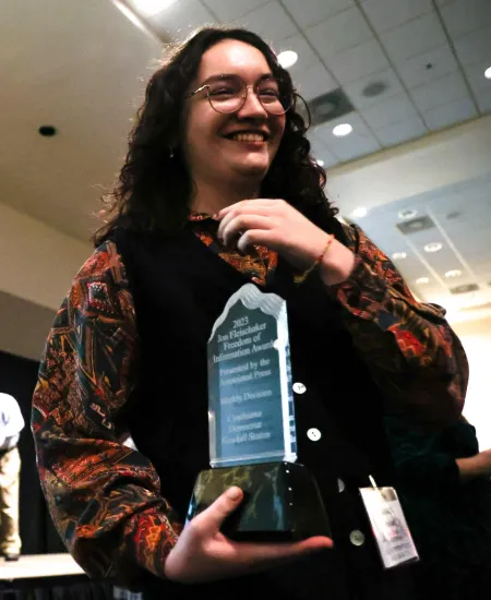 Cynthiana Democrat Regional Editor Kendall Staton accepts her Jon Fleischaker Freedom of Information Award during the Kentucky Press Association Awards on Friday, Jan. 26, 2024, at the Holiday Inn University Plaza in Bowling Green, Kentucky. The Fleischaker Award is given to journalists who demonstrate exceptional use of public records for reporting. Staton won this award less than a year after graduating college. Photo by Abbey Cutrer.