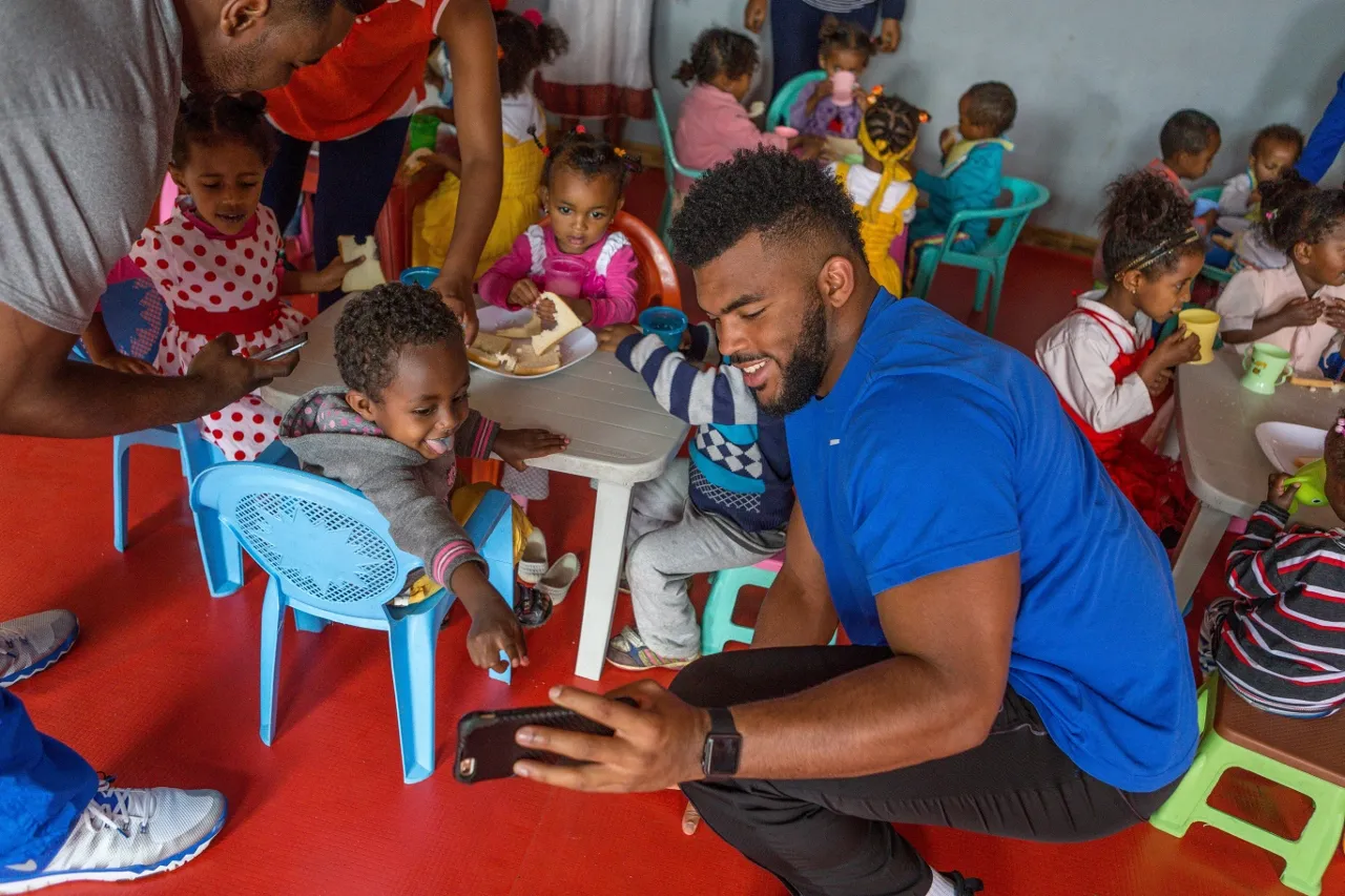 UK’s Courtney Love with children in Ethiopia. Photo by UK Athletics.