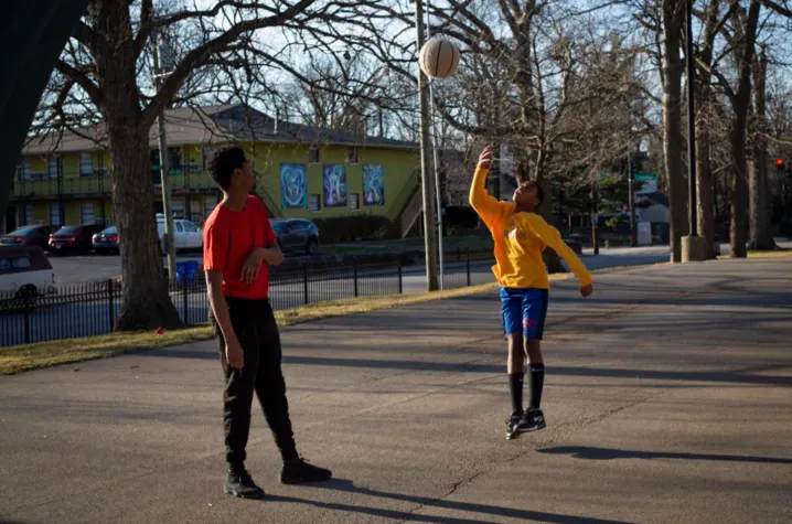 Bryan Greene, 25, and Lakell Gates, 11, play basketball on the court in Duncan Park in Lexington, Kentucky, on Sunday, Feb. 2, 2020. Photo by Arden Barnes, courtesy of Kentucky Kernel.