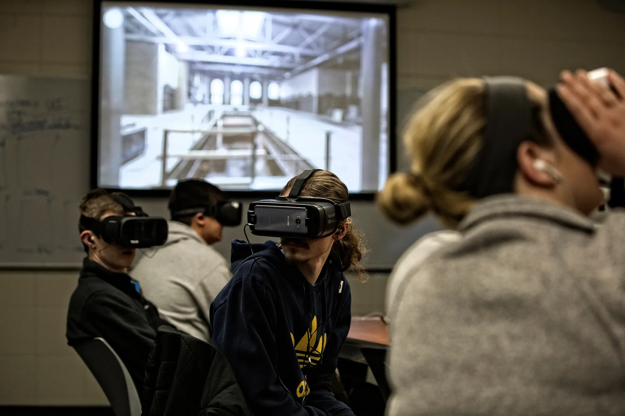 Students in an integrated strategic communication class using virtual reality headsets.