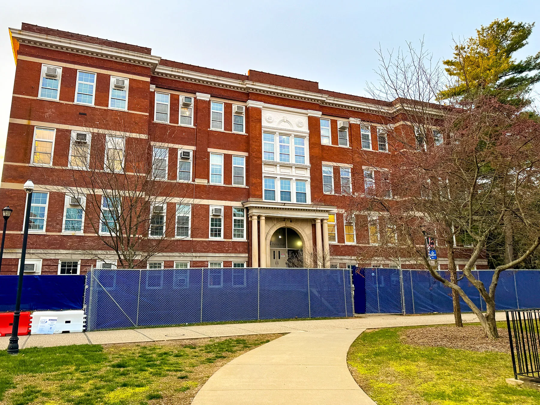 Construction fencing went up around Pence Hall in March 2024.