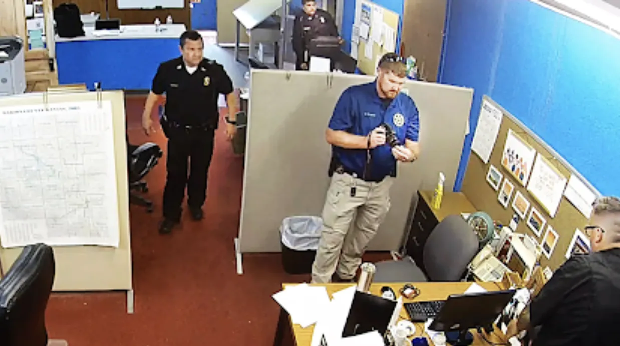 Marion County Record raid, Gruver's desk at bottom right (Screen capture of surveillance video via Kansas Reflector)