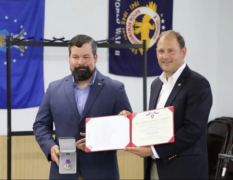 This September, CI doctoral student and veteran Joey Bates, left, was presented the Purple Heart medal by U.S. Rep. Andy Barr. Photo provided.