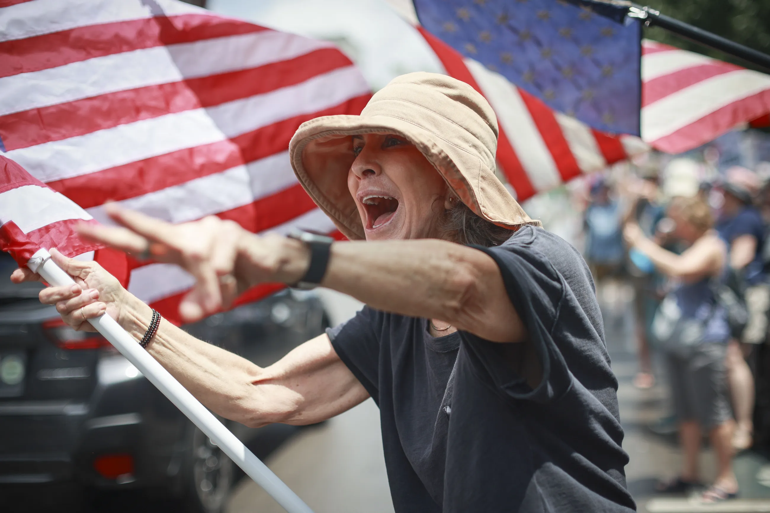 Lovell Larkin, from Lexington, yells to cars passing by during the “No Kings” protest held on Saturday, June 14, 2025, in Lexington, Ky. “I love this country,” she said. “Last time I demonstrated was during the Vietnam War.” The demonstrations are taking place in hundreds of cities across the U.S. to protest President Donald Trump’s policies. Photo by David Stephenson