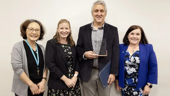 In the photo above, University of Kentucky Online Teaching Award recipient Sean Burns, third from left, is joined by (from left), Youngok Choi, Director of the School of Information Science; Brandi Frisby, Associate Director, Associate Provost for Academic Affairs; Burns; and Jennifer Greer, Dean of the College of Communication and Information.