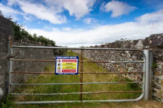 A farm safety notice sign can remind everyone that farms have hazards. (Adobe Stock photo)