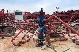 A Permian wellhead surrounded by fracking equipment. (Adobe Stock photo