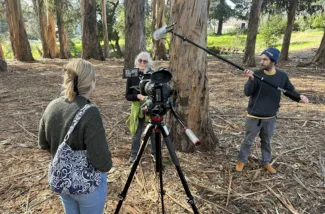 Carlson, left, interviews an artist about using eucalyptus bark for screen printing. (Photo by Joel Cohen via SEJ) 