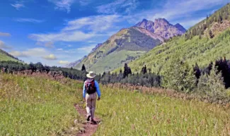 A hiker enjoys the White River National Forest, which overlaps with the Thompson Divide. (Adobe Stock photo)