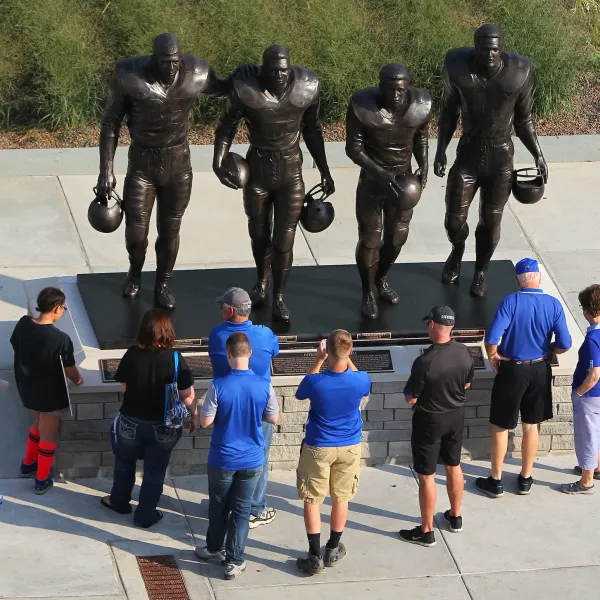Statue outside UK's stadium of the four football players who broke the SEC color line in the 1960s. (Left to right) Statue features Greg Page, Nate Northington, Wilbur Hackett, and Houston Hogg. Barry Westerman | Louisville Real Estate Photography.