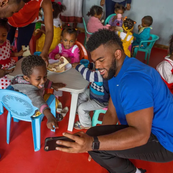 UK’s Courtney Love with children in Ethiopia. Photo by UK Athletics.