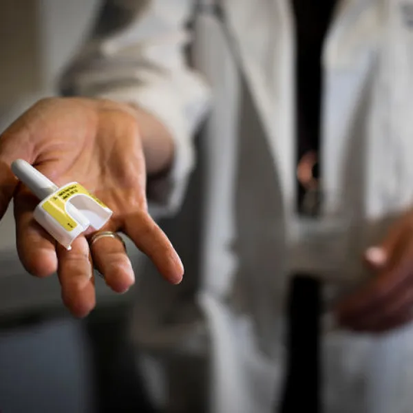 UK First Bridge Clinic's Dr. Michelle Lofwall holds up a dose of life-saving naloxone nasal spray. UK Photo | Pete Comparoni