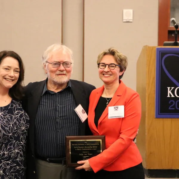 Nancy Harrington (left), KCHC director and associate dean for research in the College of Communication and Information, with KCHC Lewis Donohew Outstanding Scholar Julia van Weert (right), pose with the award’s namesake, the late Lewis Donohew, in 2018.