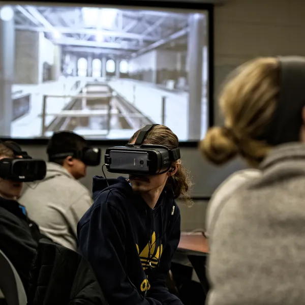 Students in an integrated strategic communication class using virtual reality headsets.