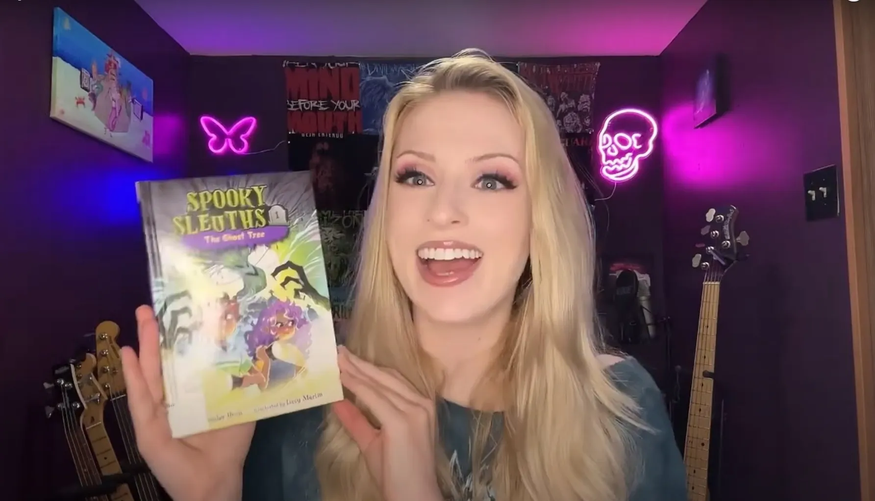 Anya Olsen-Brunot holding the book Spooky Sleuths